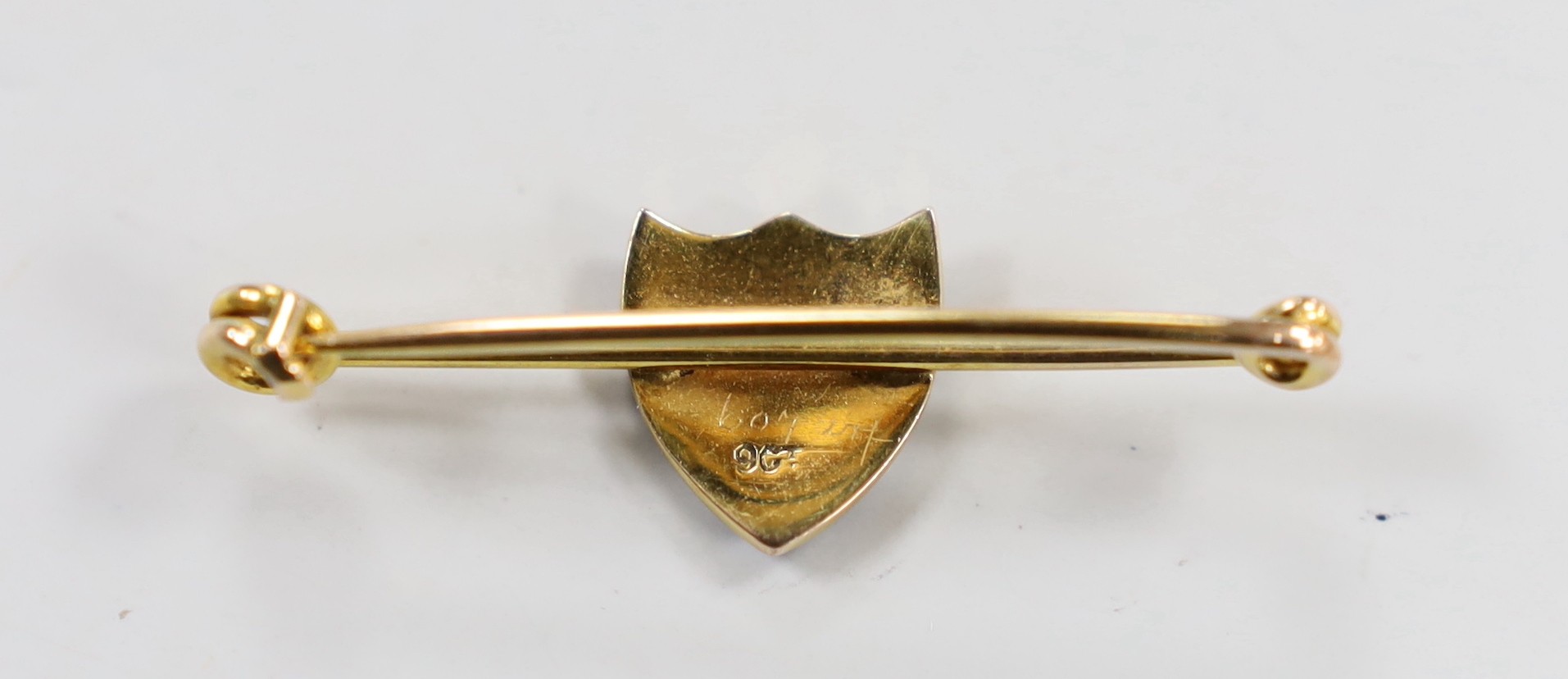 An early 20th century 9ct and polychrome enamel shield bar brooch, depicting the Royal Arms of England, 41mm, gross weight 2.9 grams.